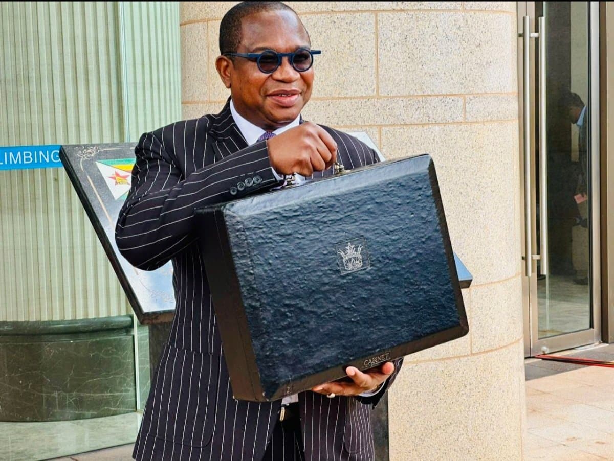 Finance Minister poses for a picture before delivering the 2024 national budget address which included a hefty sugar tax