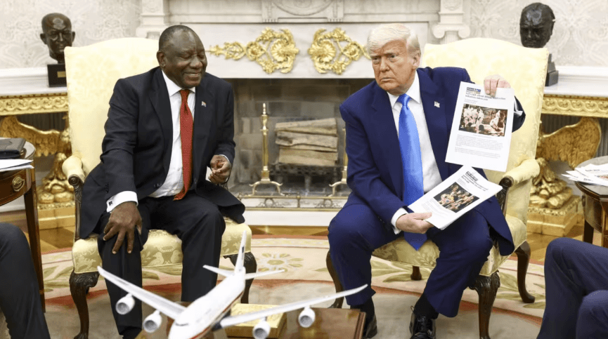 Donald Trump holds up a printed article in the White House in May, when he accused South Africa President Cyril Ramaphosa of state-sanctioned violence against white farmers