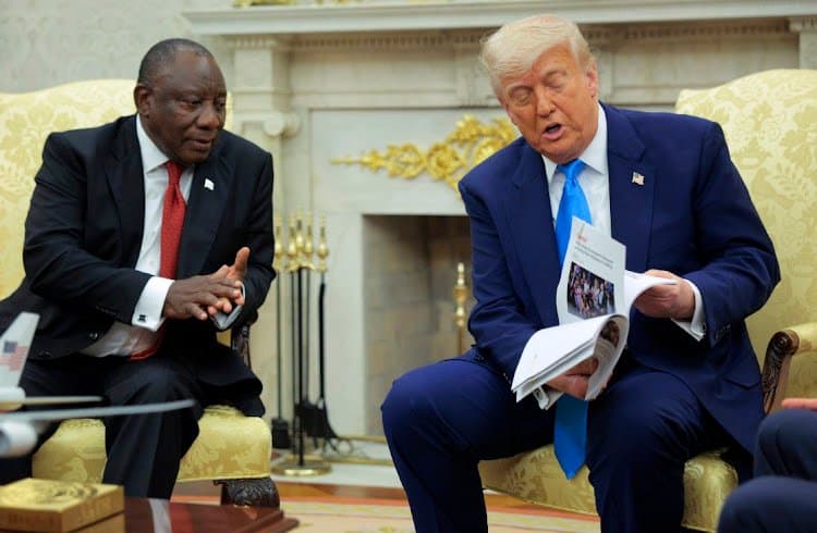 President Cyril Ramaphosa watches US President Donald Trump display articles he claims report violence against white South Africans at the White House on May 21 2025