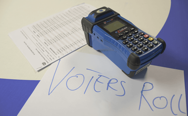 The ID scanning device, also called the zip-zip machine is used to confirm the registration status of a voter.