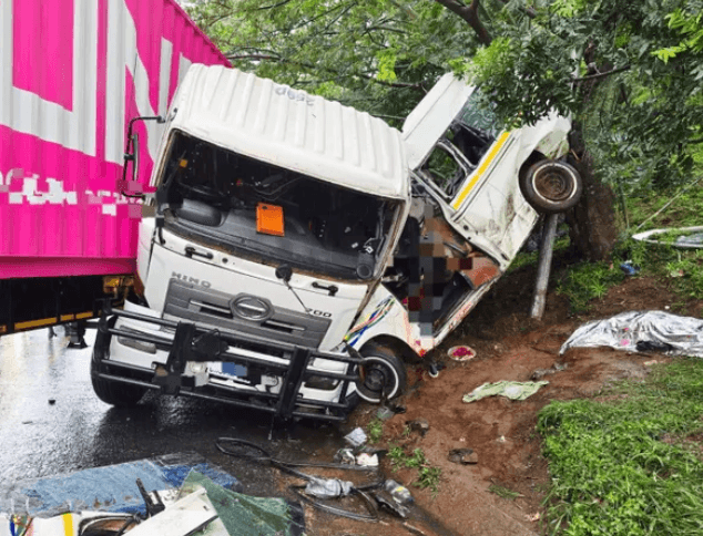 Wreckage of minibus taxi pinned against truck after fatal collision on R102 near Lotus Park, Durban