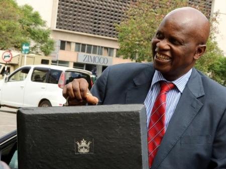 Minister of Finance Patrick Chinamasa carries the briefcase containing the 2017 National Budget at the Parliament in Harare Zimbabwe December 8 2016 REUTERSPhilimon Bulawayo | Report Focus News