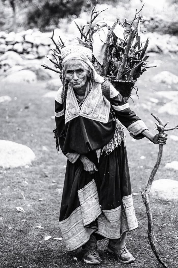 grayscale photography of woman carrying branches 3103375 | Report Focus News