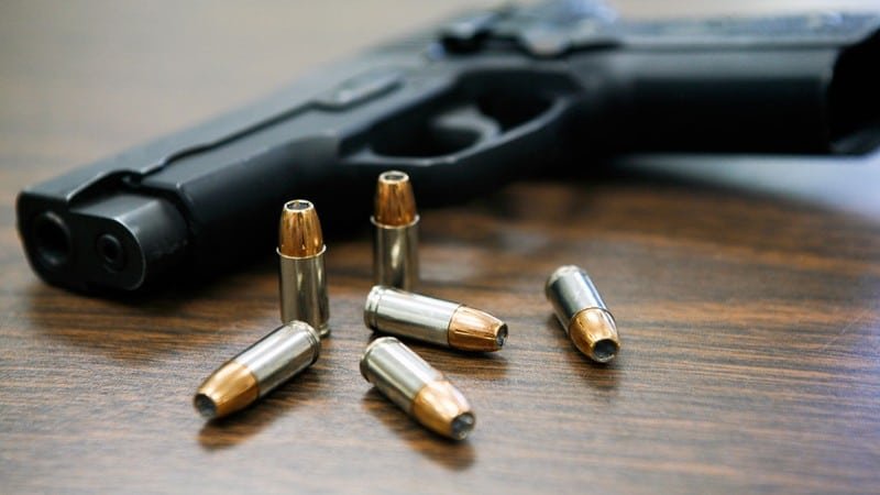 A pistol and bullets | Report Focus News