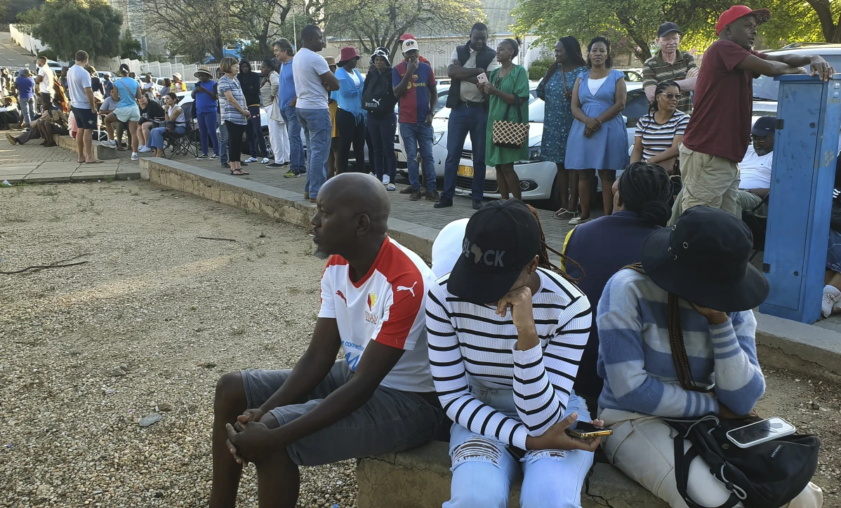 Namibian voters queuing with chairs and umbrellas outside polling station in Windhoek | Report Focus News