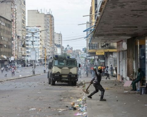 A protester throws a stone at an armoured vehicle during clashes in Mozambique's capital Maputo | Report Focus News