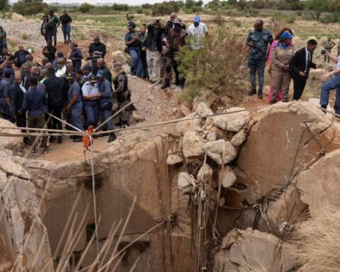 Community members watch as a mine is inspected in Stilfontein, November 15, 2024.