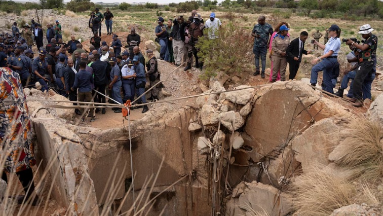 Community members watch as a mine is inspected in Stilfontein, November 15, 2024.