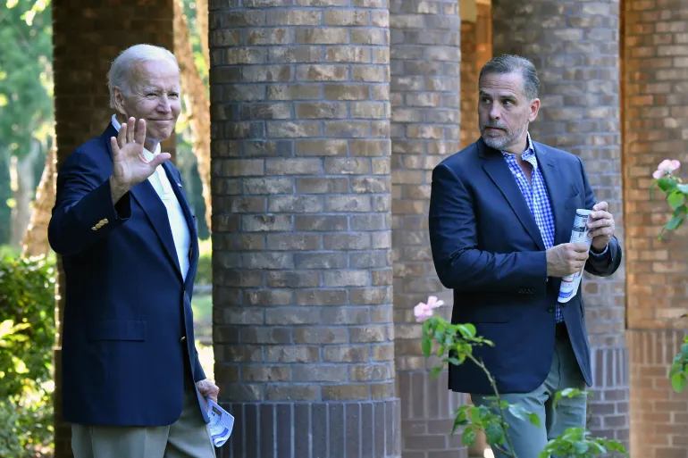 US President Joe Biden waves alongside his son Hunter Biden after attending mass at Holy Spirit Catholic Church in Johns Island, South Carolina on August 13, 2022. image AFP